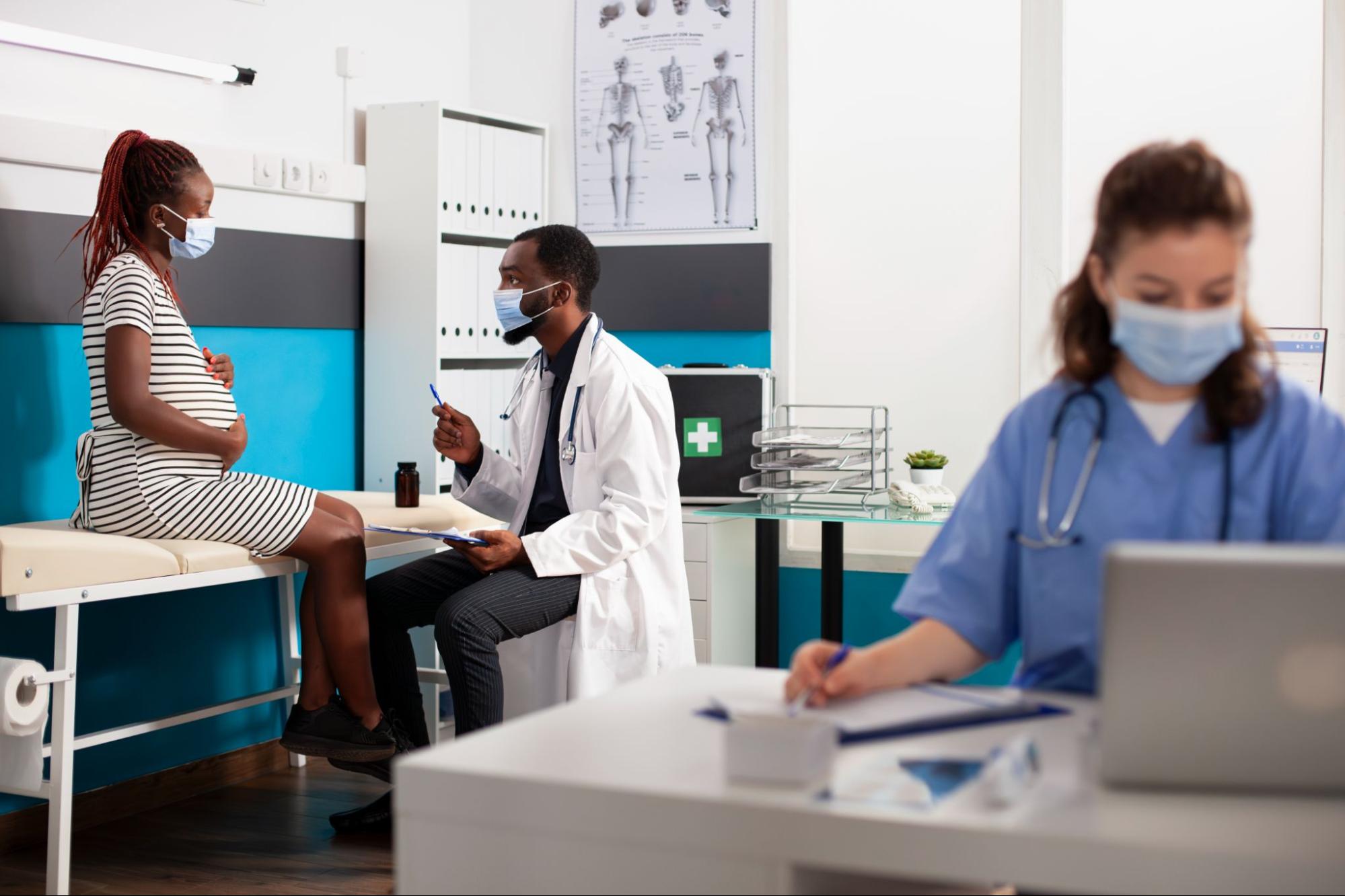 An image of a doctor helping a pregnant woman, which can be fulfilling work, which illustrates why understanding the interview process at TrueCare can put you in a position to make a difference.