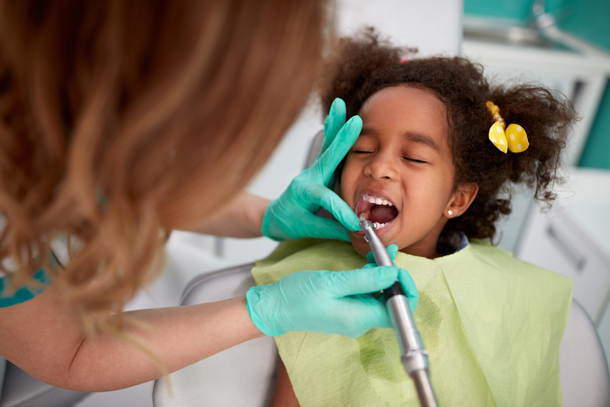 Child receiving a spring teeth cleaning for oral health