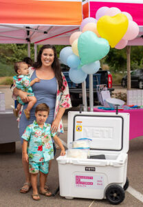 Mother with two young sons donating breast milk