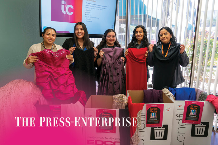 truecare-news-press-enterprise-dress-drive-featured-image-blog-700×466 TrueCare Outreach team holding up prom dresses donated for The Dresses & Dreams Project
