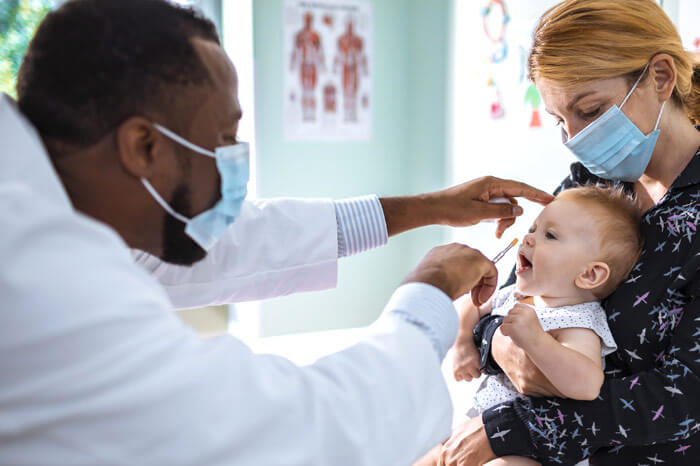 Close up of a pediatrician vaccinating his patient