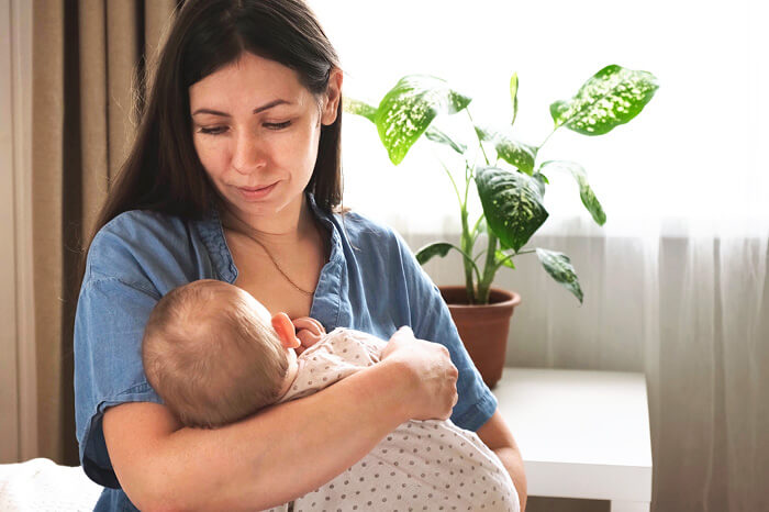A new postpartum mom breastfeeding baby