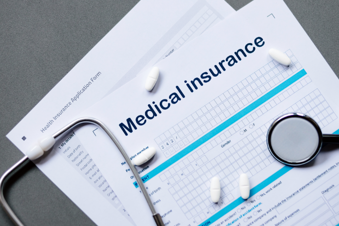 An image of medical insurance documents, which are just one representation of the employee health insurance available at TrueCare.